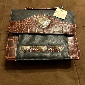 Hand crafted ostrich and alligator purse with heart accents.